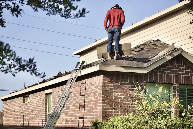 Professional roofer working on a residential roof in Boxwood Village